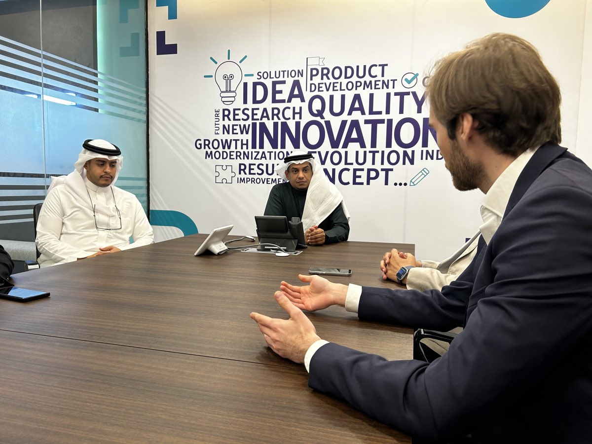 Client meeting at a boardroom table in Riyadh.