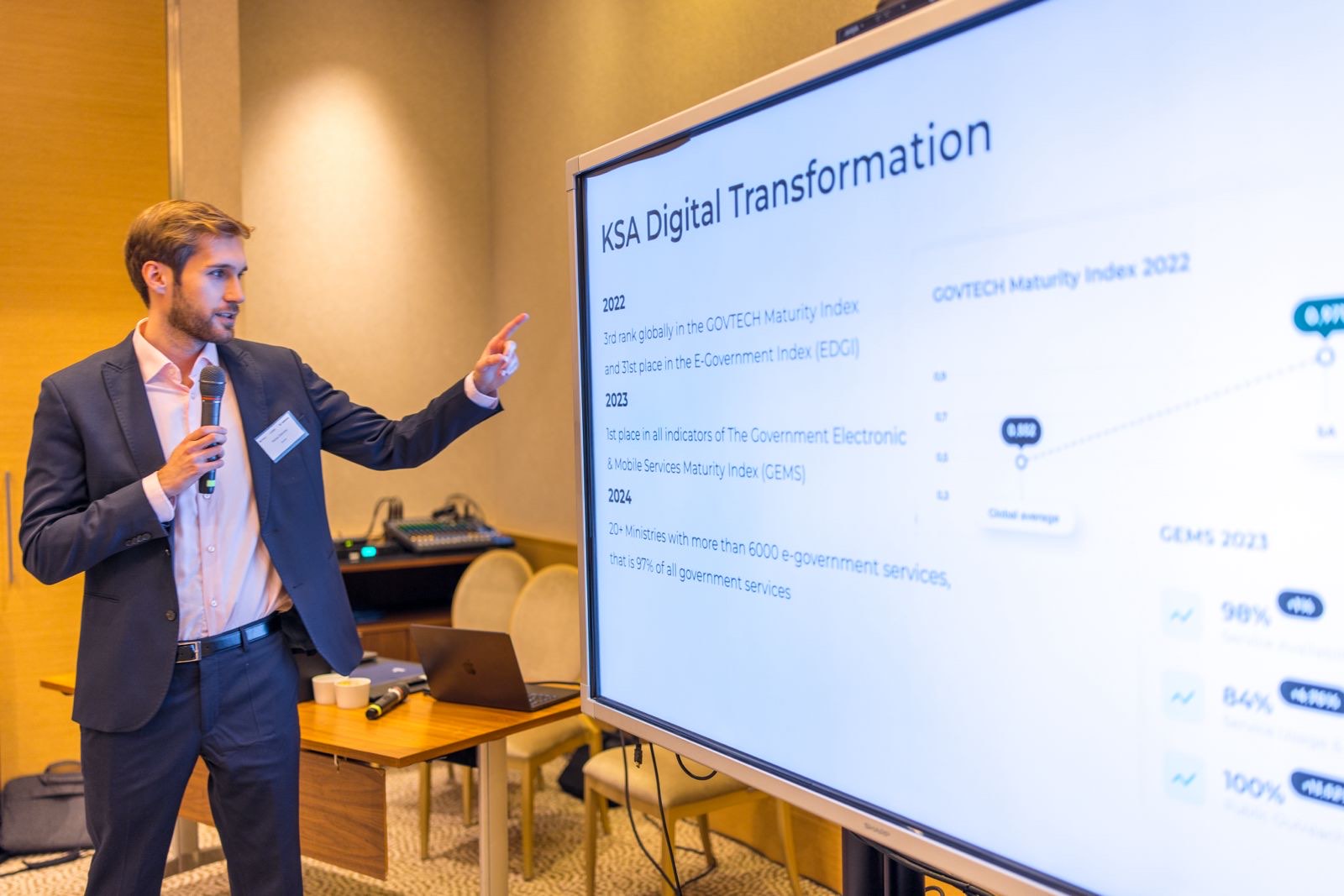 Michał Zieliński presenting a KSA Digital Transformation slide to a conference audience.