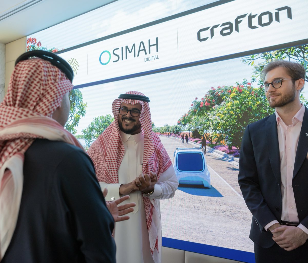 Contract signature meeting in front of a partnership screen in Riyadh.